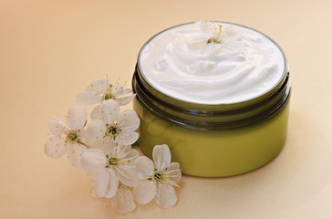 Fototapeta na wymiar container with herbal cream for skincare with flower ingredient