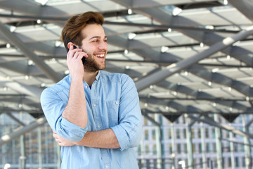 Smiling man enjoying conversation on cell phone