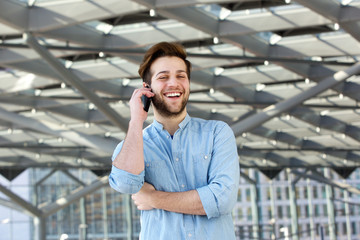 Young man laughing and talking on mobile phone