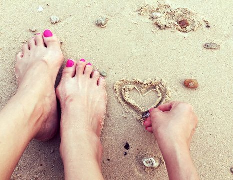 drawing heart on beach. 