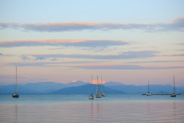 Sailing boats in the sea at sunset in Corfu's harbor