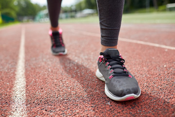 Fototapeta na wymiar close up of woman feet running on track from back