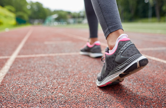 Close Up Of Woman Feet Running On Track From Back