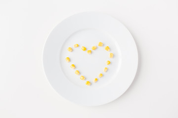 close up of plate with corn  in heart shape 
