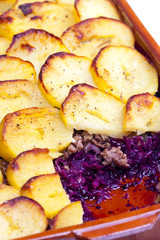 potatoes baked with pork minced meat and red cabbage