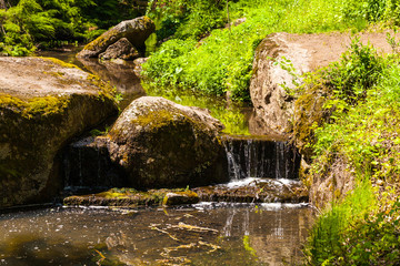 Naklejka na ściany i meble stream flowing over the stones
