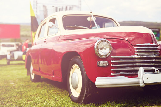 Fototapeta Retro car parked on grass