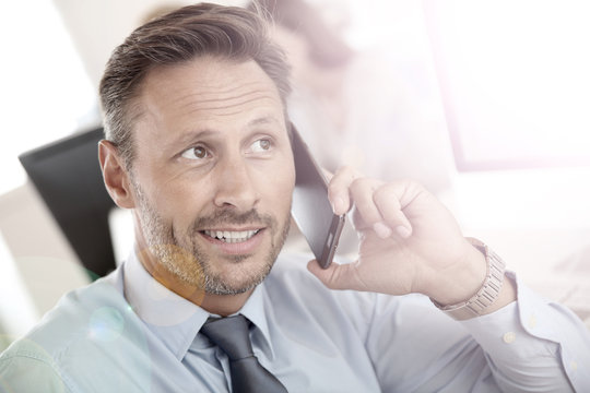 Portrait of businessman talking on mobile phone