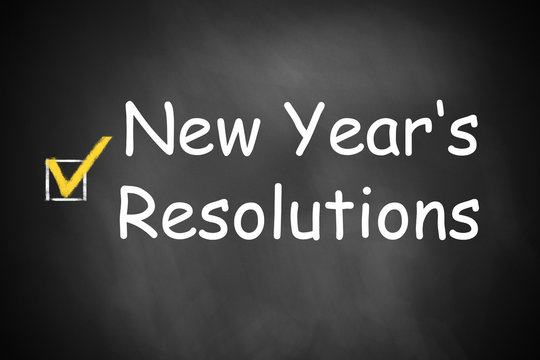 New Year's resolutions written on black chalkboard checkbox