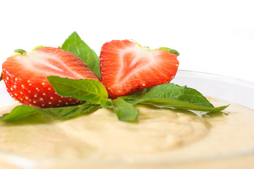 Custard dessert with fresh strawberry and mint