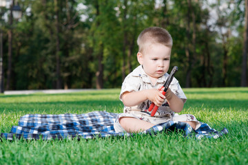 Beautiful baby in the park on the grass in the park