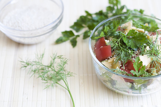 Salad: tomatos, cucumber, dill, parsley, cheese, sesame