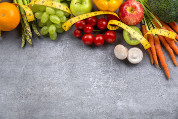 Fruits, vegetables and tape measure in diet