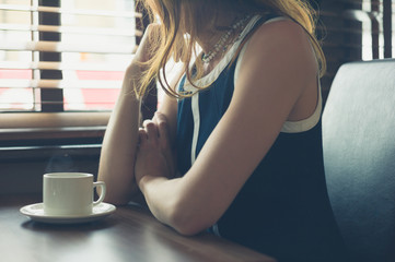 Young woman having coffee in diner