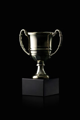 Cup. Golden cup of the winner on black background