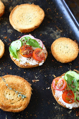 Bruschetta with vegetables on a baking tray