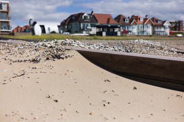 Fototapeta premium A groin on the beach with houses in background