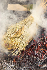 dry medicinal herb lit, white smoke