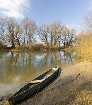 wooden boat on spring river.
