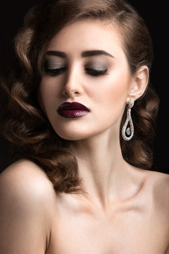 woman with evening make-up, burgundy lips and curls.
