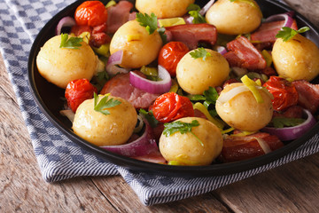 Tasty potatoes with onion, tomato and bacon