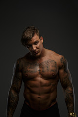 Fototapeta premium Muscular guy in deep shadows