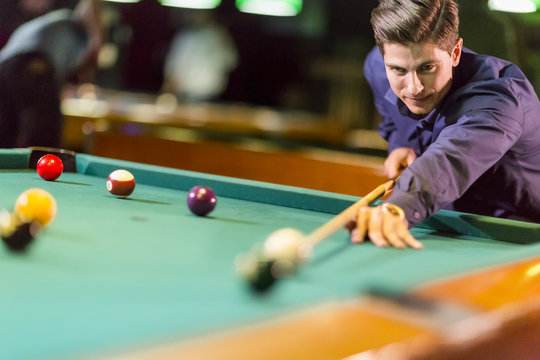 Young man playing pool