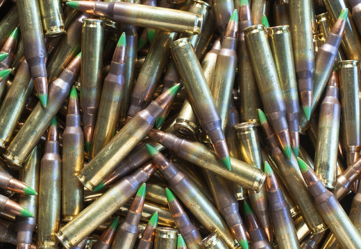 Pile of ammo with green tipped bullets