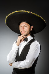 Mexican man wears sombrero isolated on white