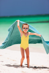 Cute little girl having fun on beach vacation