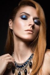 red-haired girl with bright blue make-up