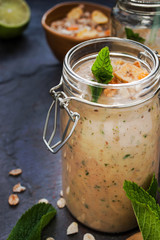 Fruit smoothie with mint in a glass jars