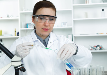 female researcher with glass equipment in the lab