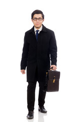 Young man holding suitcase isolated on white