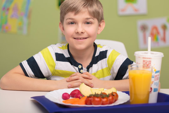 Smiling boy with school lunch