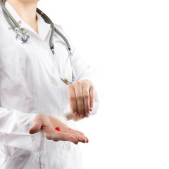 First aid - Female doctor's hand giving red pills isolated on wh