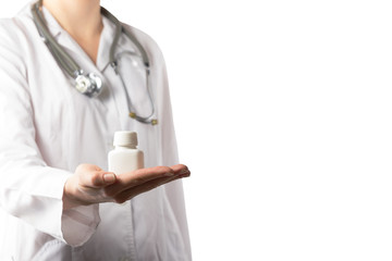 Female doctor holding up a bottle of tablets or pills with a bla