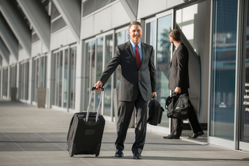 Handsome CEO executive traveling on business trip at the airport 