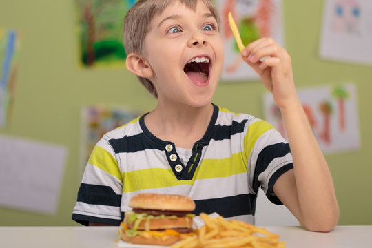 Happy Boy Eating French Fries