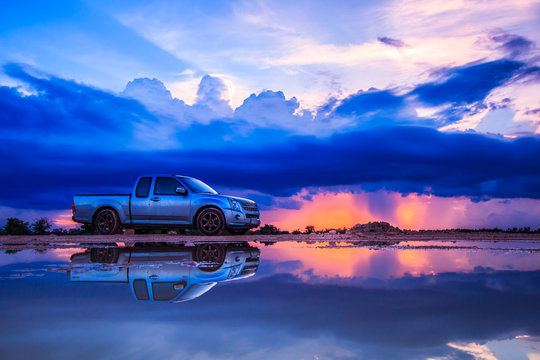 Car and sunset sky