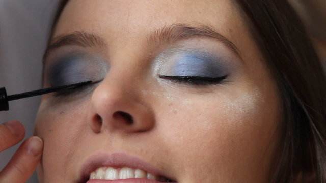 Makeup artist applying black eye liner to model eye. Full HD