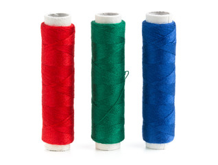Red, green and blue sewing yarn rolls