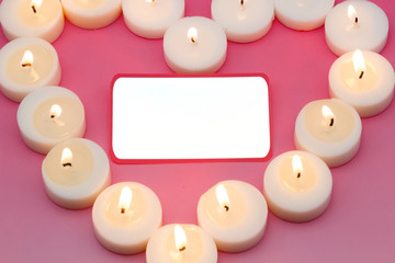 message board with a heart shape made from candles