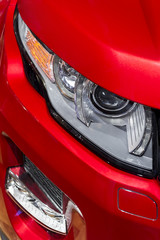 Headlight with led lamps and hood of red sport modern car 