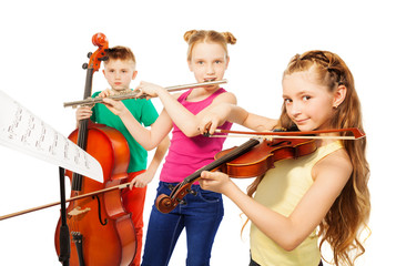 Two girls and boy playing on musical instruments © Sergey Novikov