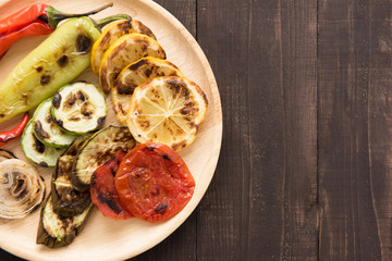 Organic grilled vegetables with pappers on wooden background