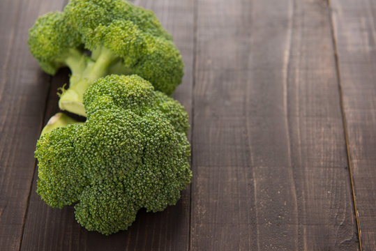 Fresh green broccoli on the wooden background