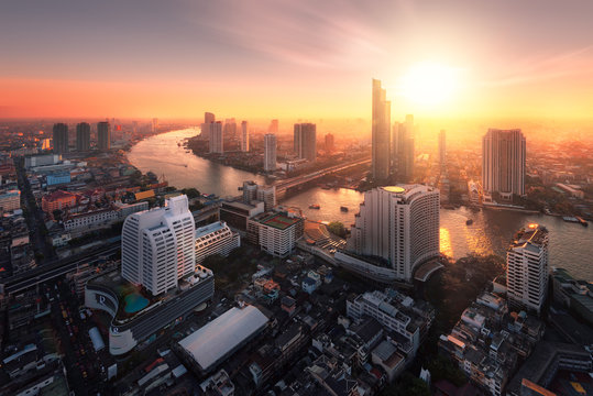 Bangkok City Sunlight Warm Orange,sunrise In Morning Rooftop View, Chao Phraya River The Office Buildings In Bangkok City  Skyline Top View Business Office In Capital City Of Thailand Asian 