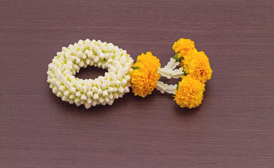 Close up jasmine garland of flowers on black wooden background