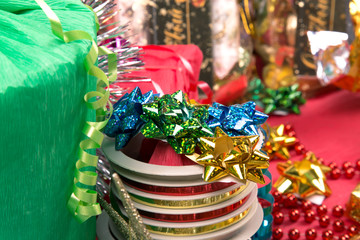 multicolor bow on ribbon roll near gift-box